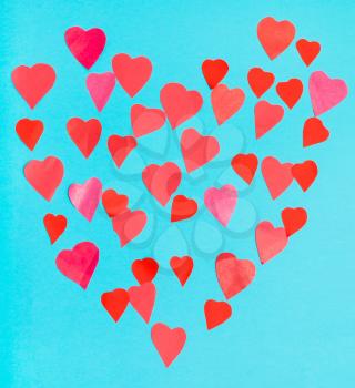 collage of big heart filled by little pink and red hearts on blue turquoise pastel paper