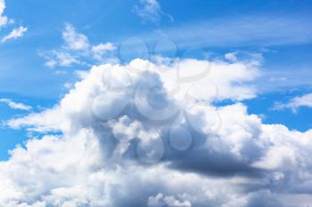 natural background - bottom view of large white and gray clouds in blue sky on summer day