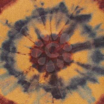 textile background - abstract concentric circles hand-painted on brown silk in tie-dye batik technique