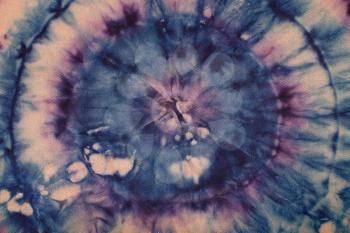 panoramic textile background - abstract spotted blue and purple concentric circles hand-painted on silk in tie-dye batik technique