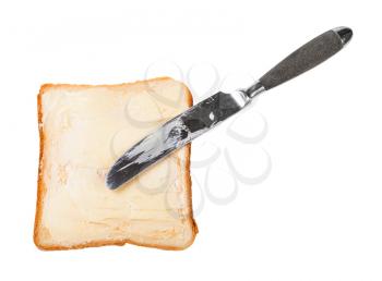 top view of knife and open sandwich with toast and butter (bread and butter) isolated on white background