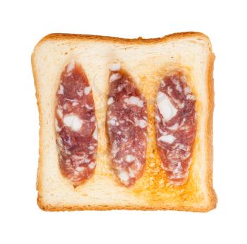top view of open sandwich with toast and three slices of cured sausage isolated on white background