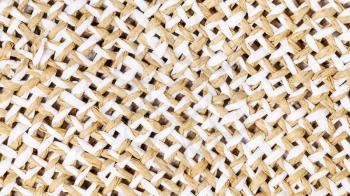 textile panoramic background - weaving of summer straw hat from toyo fibers close up
