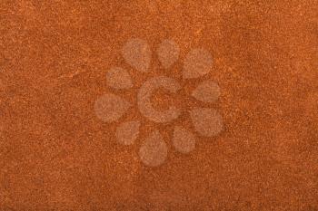 textured background from orange brown suede close up