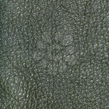 textured square background from dark olive green leather close up