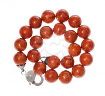 top view of spiral necklace from polished red coral balls isolated on white background