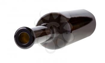 overturned empty dark brown wine bottle isolated on white background