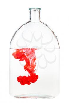 red ink dissolves in water in glass flask isolated on white background