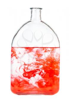 red watercolour dissolves in water in bottle isolated on white background