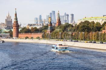 view of Kremlin with Moscow-city and skyscraper of Ministry of Foreign Affairs on background from Bolshoy Moskvoretsky Bridge of Moskva River on sunny autumn day