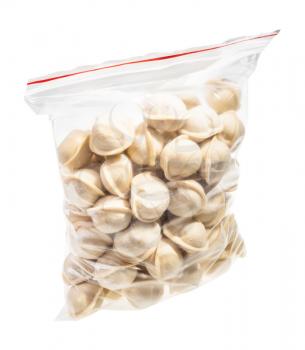 transparent bag with frozen Pelmeni (russian dumplings filled with minced meat) isolated on white background