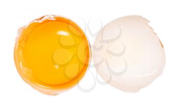 top view of separated egg yolk in half of shell and empty eggshell isolated on white background