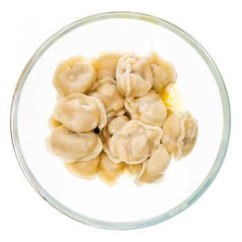 top view of buttered Pelmeni (russian dumplings filled with minced meat) in glass bowl isolated on white background