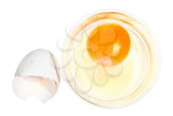 top view of broken chicken egg in glass bowl and empty white shell isolated on white background
