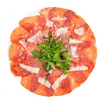 top view of served Carpaccio (thinly sliced raw beef fillet) decorated by Parmesan, Arugula on white plate isolated on white background