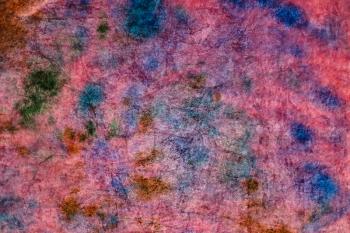 textile background - pink velvet stained in tie-dye abstract batik technique