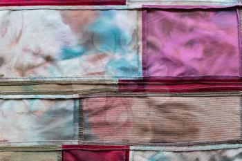 textile background - hand-sewn patchwork cloth from velvet and batik pieces