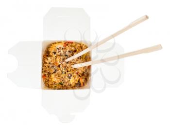 top view of chinese fast food - fried rice with battered prawns in disposable cardboard box with wooden chopsticks isolated on white background