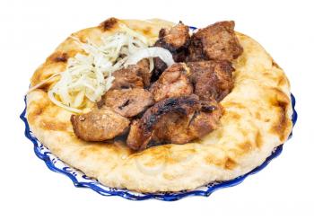 portion of kebab on flatbread on plate isolated on white background