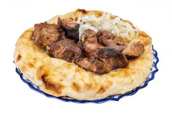 grilled kebab on flatbread on plate isolated on white background