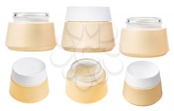 set of yellow shiny jars for cosmetic cream with white lid isolated on white background