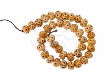 top view of spiral string of carved bone beads isolated on white background