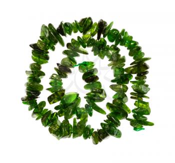 top view of spiral string of beads from natural tumbled chrome diopside gemstone isolated on white background
