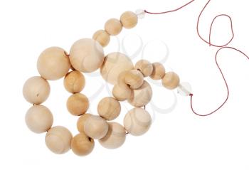 top view of tangled string of wooden beads isolated on white background