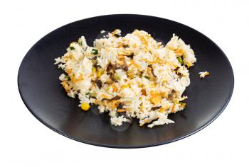 chinese cuisine - boiled jasmine rice with egg and fried vegetables (mushrooms, carrots, corn seeds, green onions) on black plate isolated on white background