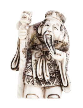 antique japanese netsuke - wise man with staff carved from ivory isolated on white background