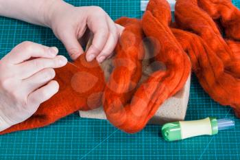master class of repairing fleece glove using Needle felting process - craftsman binding fibers in felt with felting needle