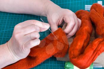 master class of repairing fleece glove using Needle felting process - craftsman fixes fibers in felt with felting needle