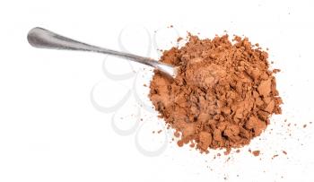 top view of pile of ground carob powder with steel spoon isolated on white background