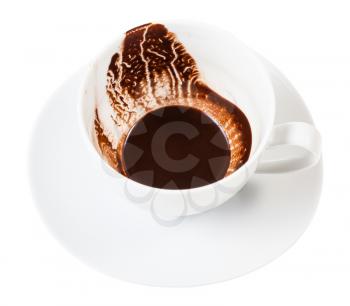 divination on carob drink sediments - white porcelain cup with carob grounds on saucer isolated on white background
