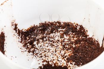 divination on coffee grounds - coffee sediments in white porcelain cup close up