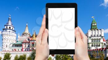travel concept - tourist photographs of Kremlin in Izmailovo district in Moscow city on smartphone with empty cutout screen with blank place for advertising