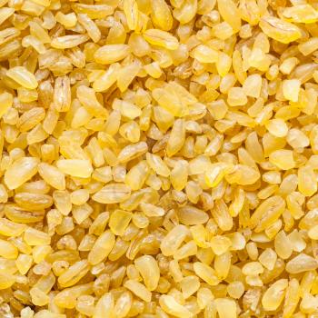 food square background - bulgur (burghul) groats, parboiled, dried and crushed wheat grains close up