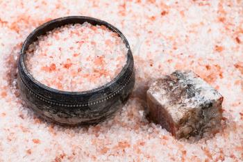 old silver salt cellar, raw natural pink Halite mineral and grained Himalayan Salt close up