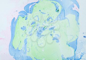abstract spots handpainted in fluid acrylic flow painting technique by blue and green paints on white and pink textured paper background
