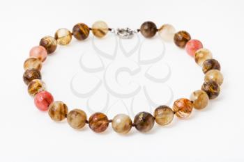 necklace from translucent agate gemsones on white paper background