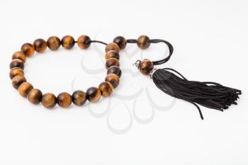 worry beads from tiger's eye gemstones on white paper background
