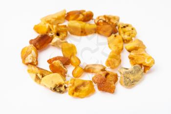 coiled necklace from natural raw yellow amber nuggets on white paper background