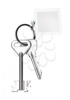pair of door keys on keyring with blank keychain isolated on white background