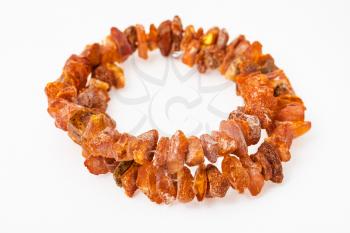 bracelet from natural rough amber nuggets on white paper background