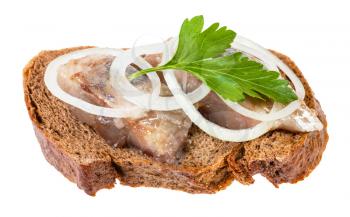 open sandwich with rye bread and pickled herring decorated of onion rings and fresh green parsley leaf isolated on white background