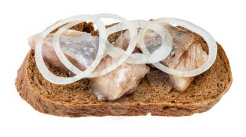 open sandwich with rye bread and pickled herring decorated of onion rings isolated on white background
