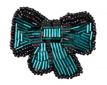 handcrafted bow tie brooch from glass green bugles and black beads isolated on white background