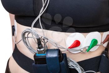 sensors and recorder of Holter monitoring for electrocardiogram are attached to female torso