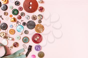 top view of many sewing objects on pink background with blank copyspace