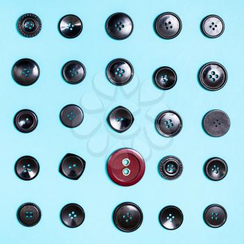 top view of different button between black buttons on blue background